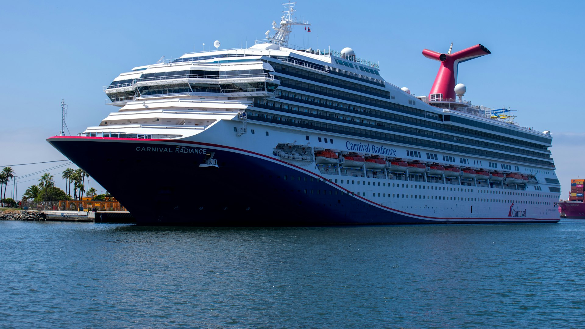 Carnival cruise ship with its red winged funnel docked in port