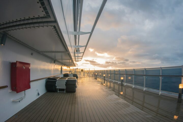 Empty promenade deck on a cruise ship at sunset