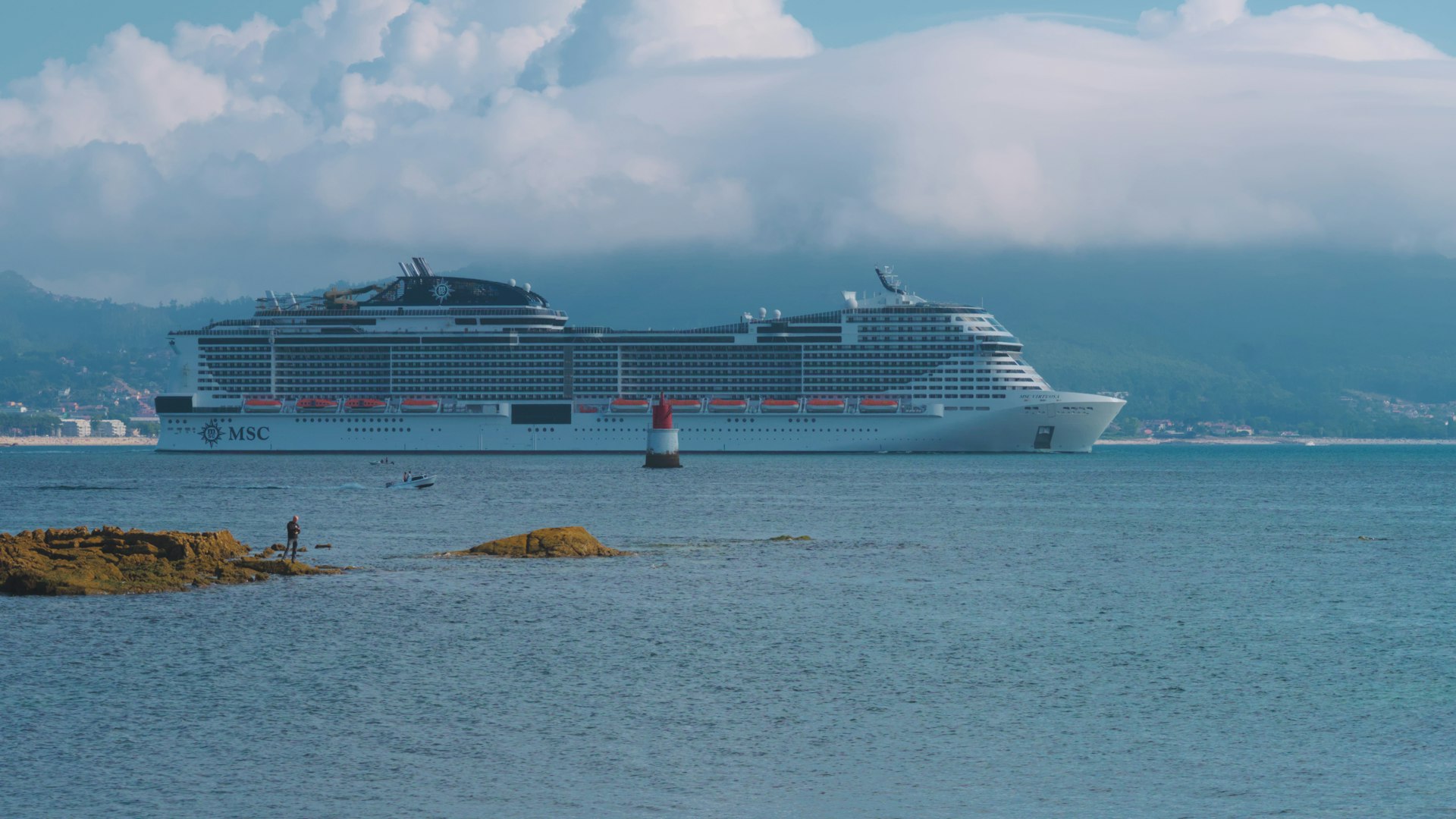 MSC Virtuosa cruise ship sailing near the shore