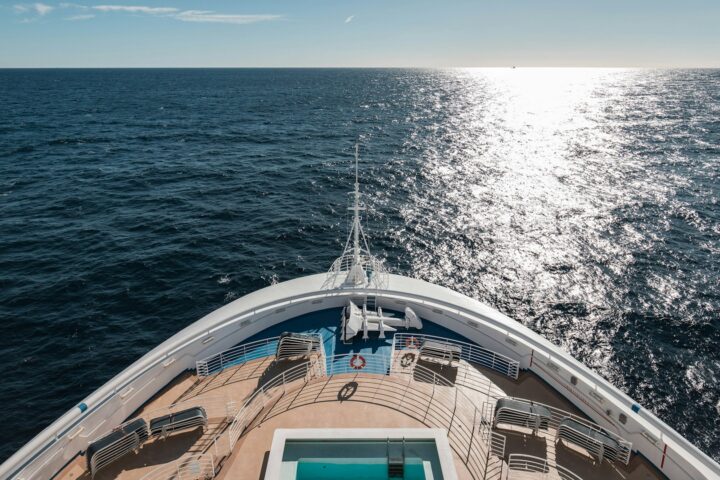 Cruise ship bow heading into sunlight on the open ocean