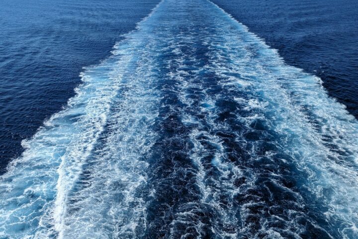 White wake trailing behind a ship on the open ocean
