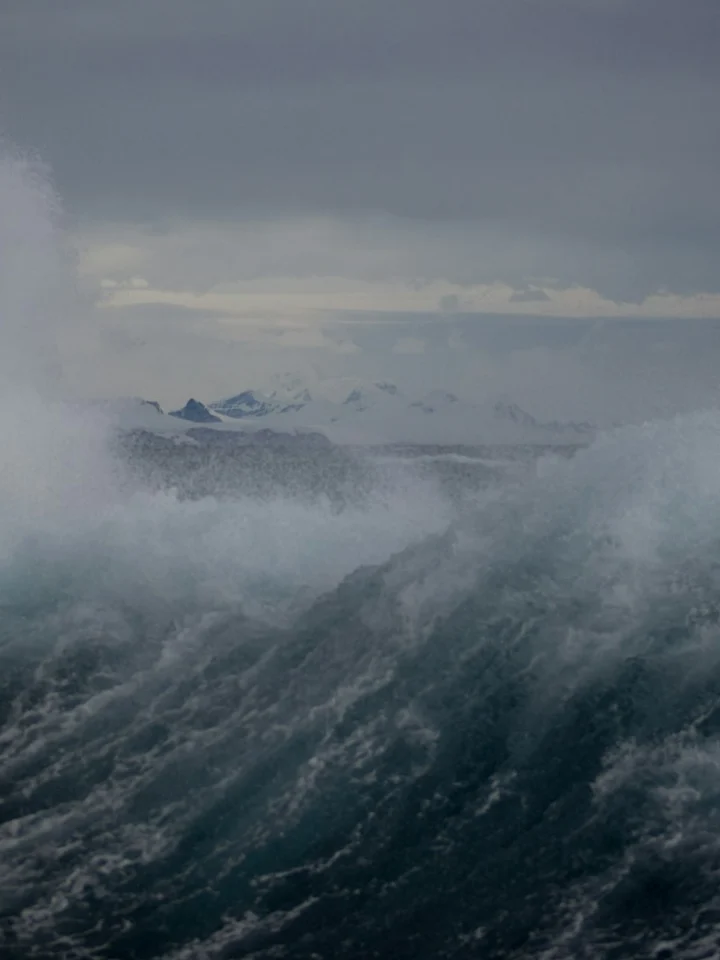 Large waves breaking beside a ship in heavy seas