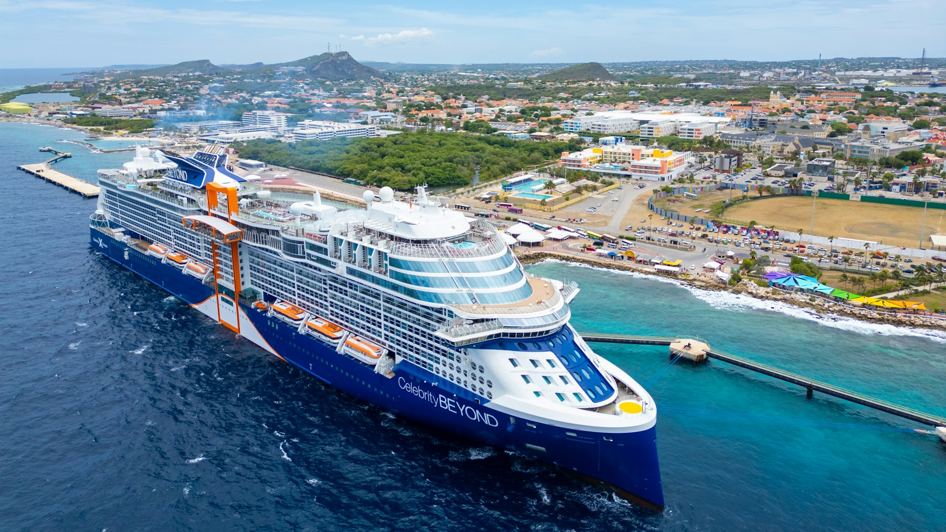 Celebrity Beyond cruise ship arriving at a pier in Curaçao, seen from above