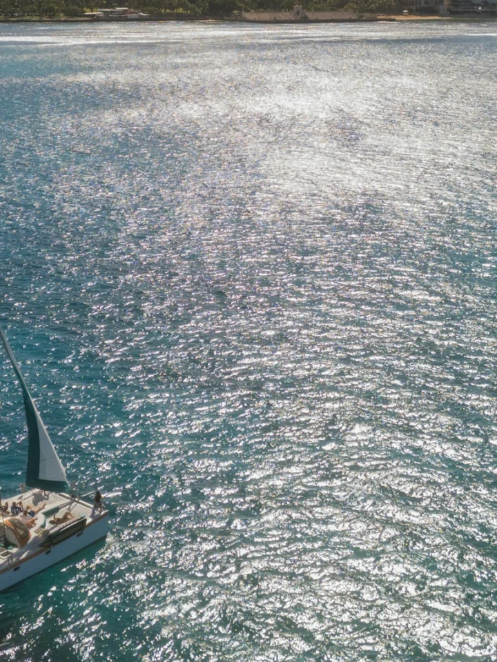 Catamaran sailing off Waikiki with Diamond Head in the background