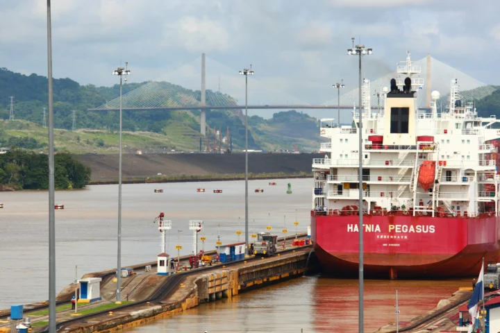 Ship inside a lock chamber of the Panama Canal with the Centennial Bridge behind