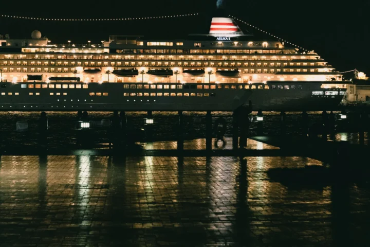 Cruise ship lit up at a pier in Japan at night