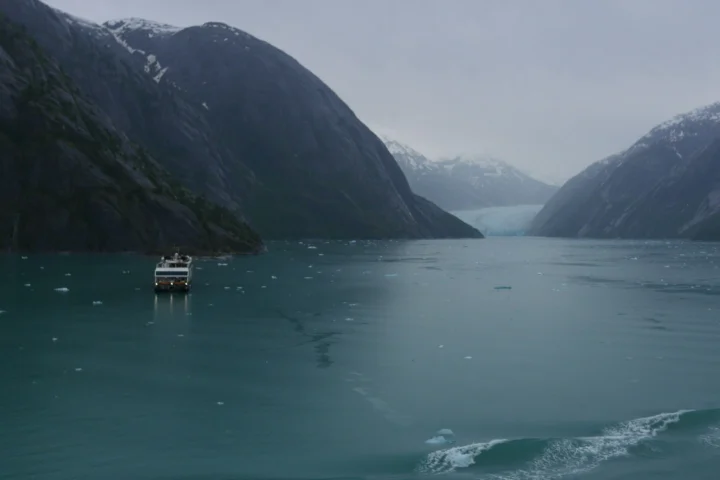 Small expedition ship heading toward a glacier in Tracy Arm fjord, Alaska