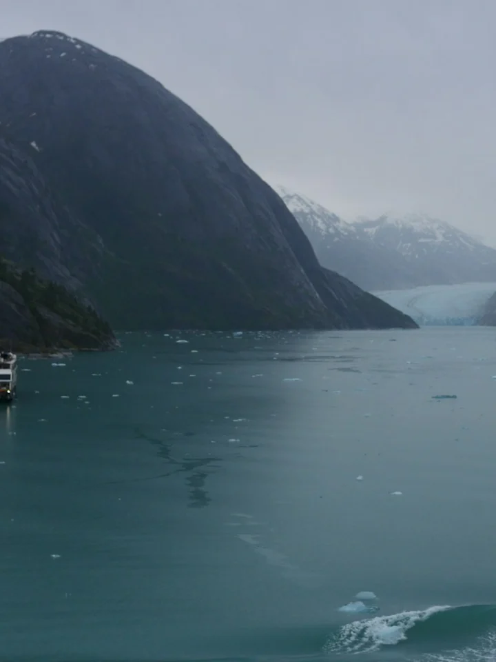 Small expedition ship heading toward a glacier in Tracy Arm fjord, Alaska